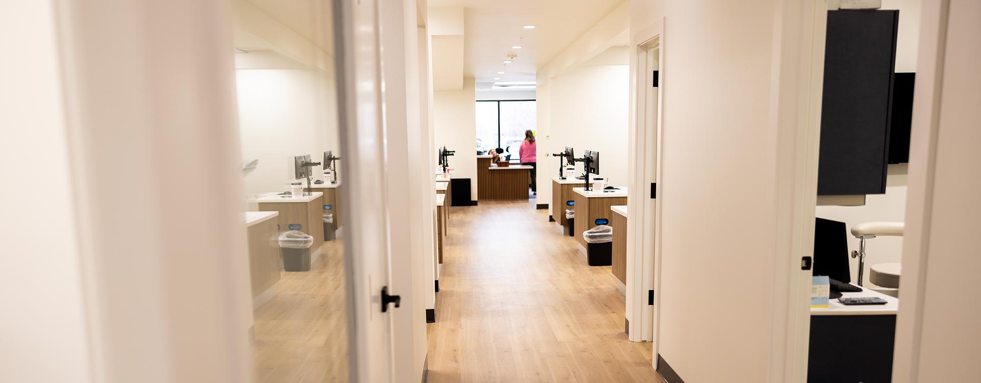 Bright hallway lined with open treatment bays